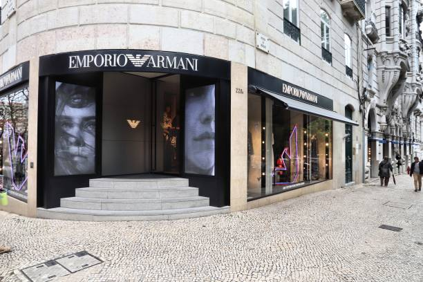 Is Armani Exchange considered cheap - A woman wearing Armani Exchange clothing and accessories, standing in front of a luxury store.